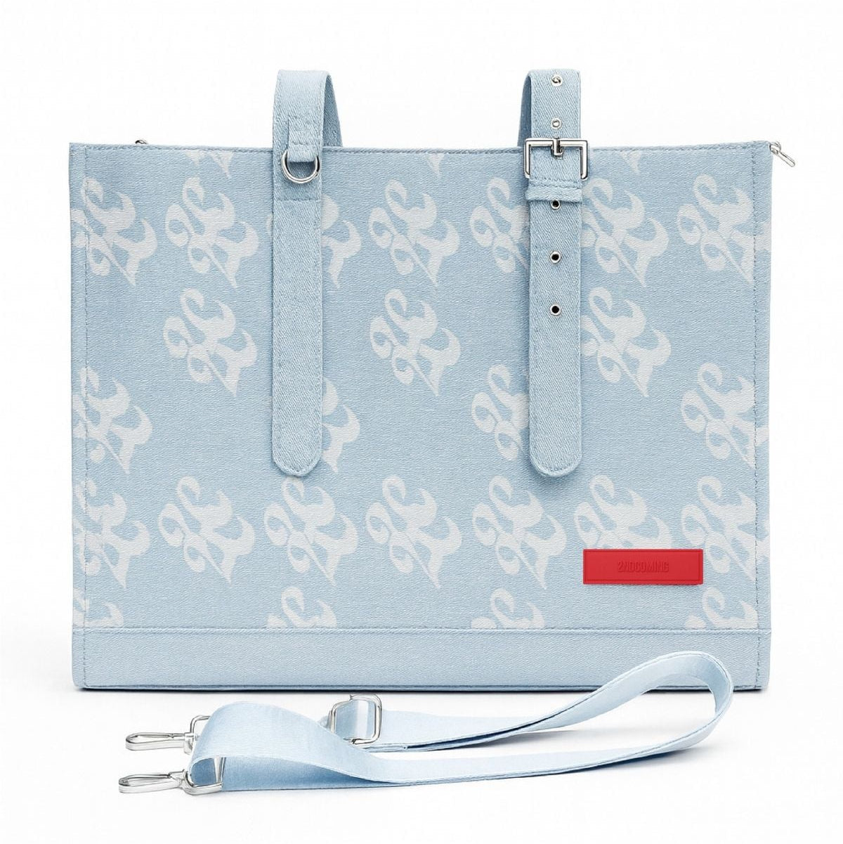 Light blue tote bag with white pattern and red label on a white background